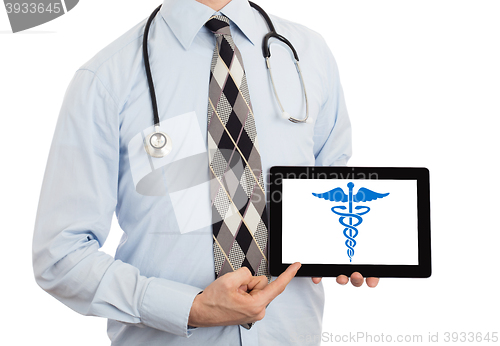 Image of Doctor holding tablet - Caduceus symbol