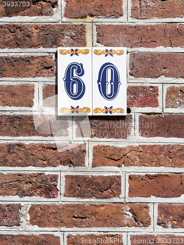 Image of House number on a red brick wall in the Netherlands