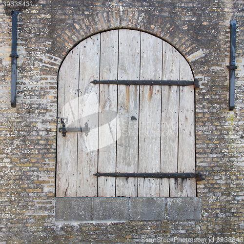 Image of Old wooden door in a wall