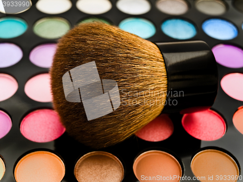 Image of Multicolored Eye Shadows and Cosmetic Brush