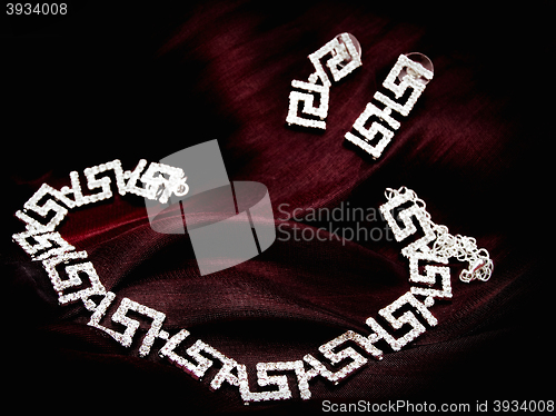 Image of Necklace and Earrings at Red Fabric