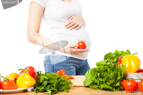 Image of Pregnant woman with tomato