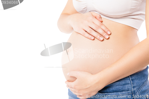 Image of Unrecognizable pregnant woman embracing her belly