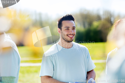 Image of happy volunteer man in park