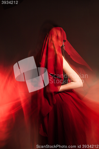 Image of Unrecognizable woman covered with red cloth