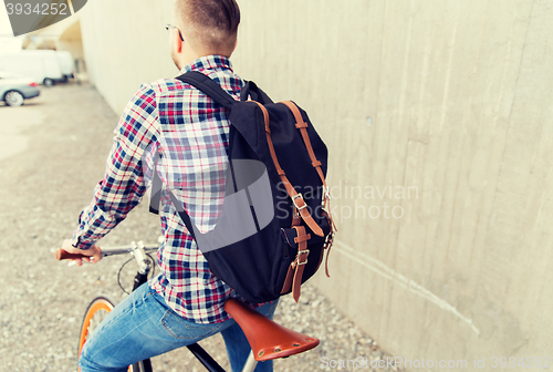 Image of hipster man with fixed gear bike and backpack