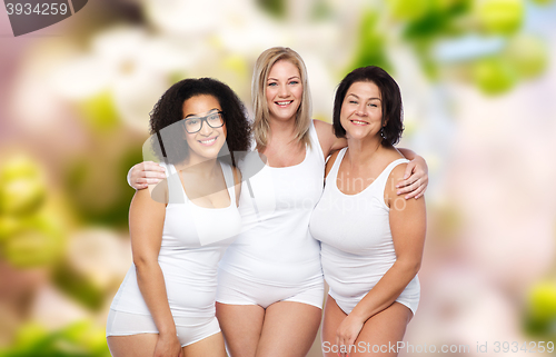 Image of group of happy plus size women in white underwear