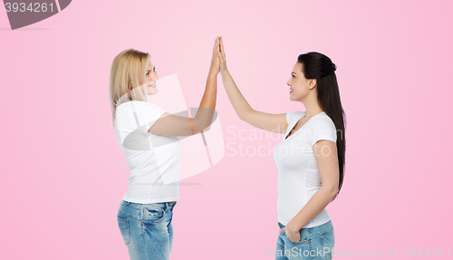 Image of group of happy different women in white t-shirts