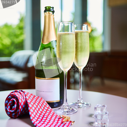 Image of bottle of champagne and two glasses on the table
