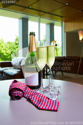 Image of bottle of champagne and two glasses on the table