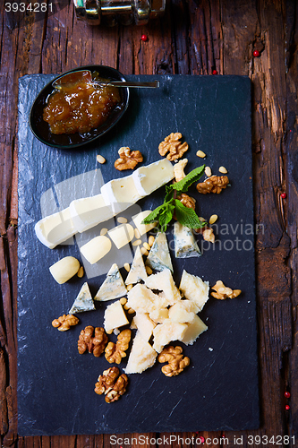 Image of various cheeses on a wooden background