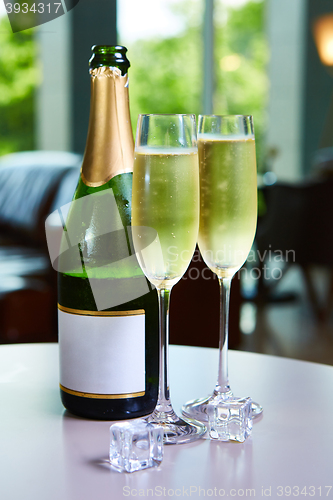 Image of bottle of champagne and two glasses on the table