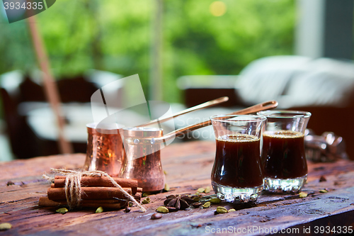 Image of To pour arabic coffee in cups on wooden background.