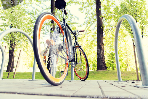 Image of close up of bicycle locked at street parking