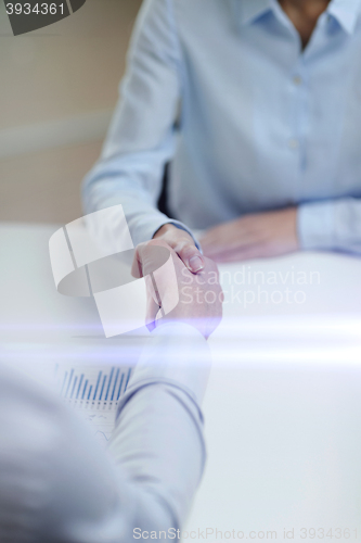 Image of businesswoman and businessman shaking hands