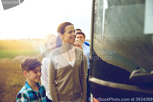 Image of group of happy passengers boarding travel bus