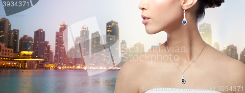 Image of close up of woman with earring and pendant