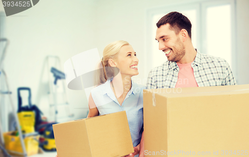 Image of couple with cardboard boxes moving to new home