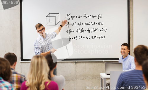 Image of group of students and teacher at white board