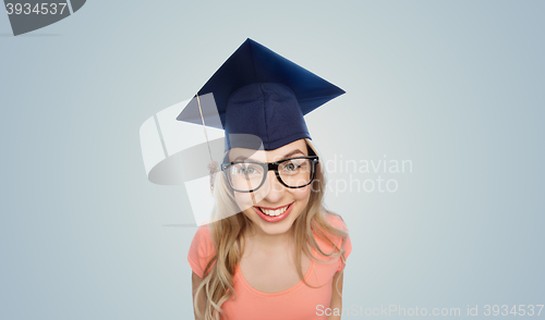 Image of smiling young student woman in mortarboard