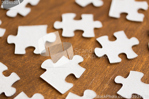 Image of close up of puzzle pieces on wooden surface