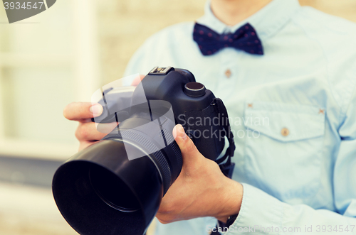 Image of close up of male photographer with digital camera