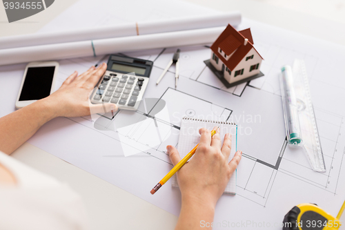 Image of close up of architect hand counting on calculator