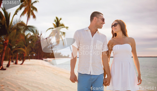 Image of happy smiling couple over summer beach and sea
