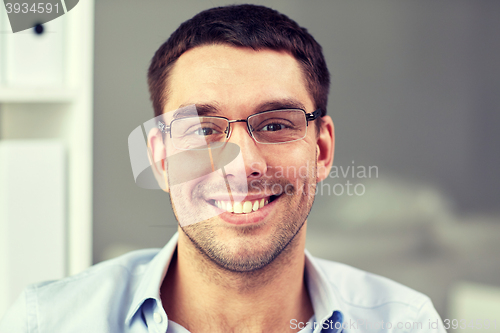 Image of portrait of businessman in eyeglasses at office