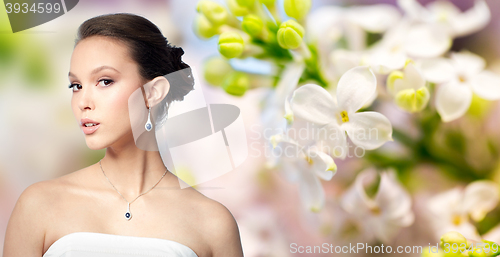 Image of beautiful asian woman with earring and pendant