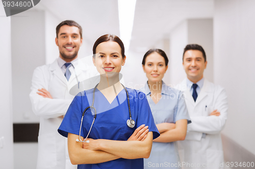 Image of happy group of medics or doctors at hospital