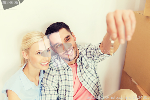 Image of couple with key and boxes moving to new home