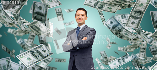 Image of happy businessman over dollar cash money rain