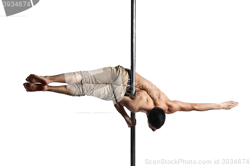 Image of Young strong pole dance man isolated