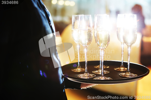 Image of Waiter serving champagne on a tray