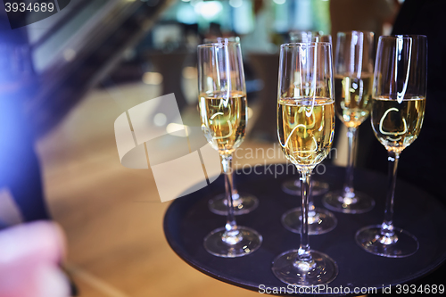 Image of Full glasses of Champagne on tray