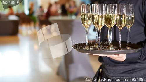 Image of Waiter serving champagne on a tray