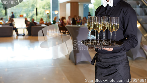 Image of Waiter serving champagne on a tray