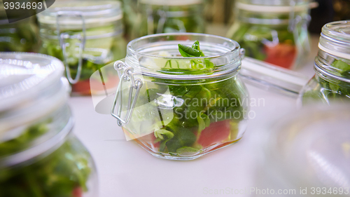 Image of vegetable salad in glass jar on white background