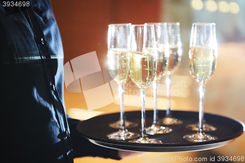 Image of Waiter serving champagne on a tray