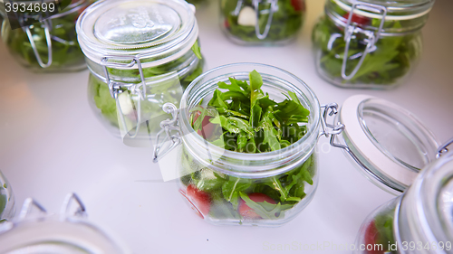 Image of vegetable salad in glass jar on white background