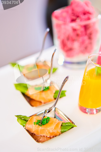 Image of Appetizer plate of sauteed asparagus wrapped in thin slices smoked salmon