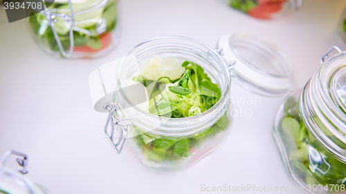 Image of vegetable salad in glass jar on white background