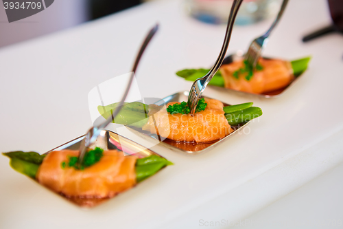 Image of Appetizer plate of sauteed asparagus wrapped in thin slices smoked salmon