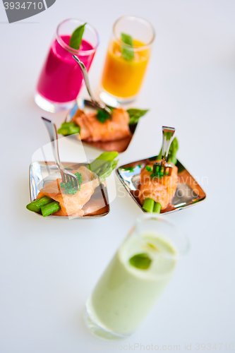 Image of Appetizer plate of sauteed asparagus wrapped in thin slices smoked salmon