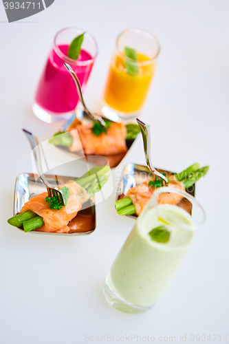 Image of Appetizer plate of sauteed asparagus wrapped in thin slices smoked salmon