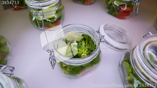 Image of vegetable salad in glass jar on white background