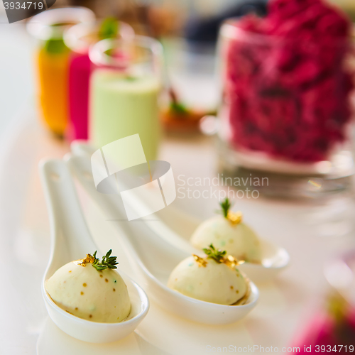 Image of Appetizer pike caviar decorated with gold and green.