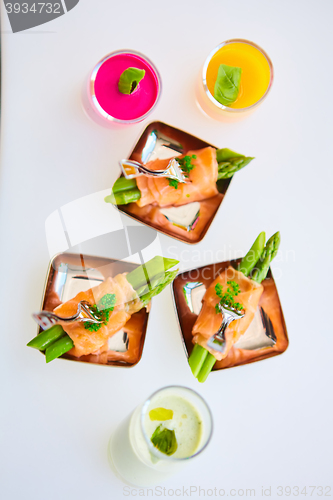 Image of Appetizer plate of sauteed asparagus wrapped in thin slices smoked salmon