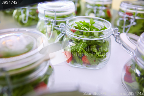 Image of vegetable salad in glass jar on white background